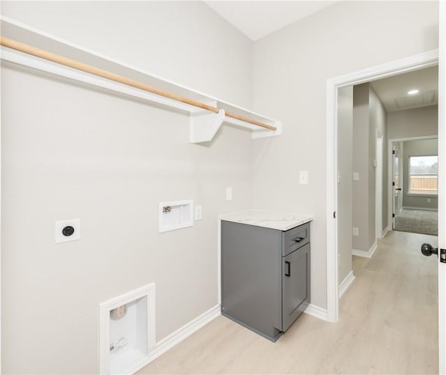 clothes washing area featuring light wood-style flooring, baseboards, hookup for an electric dryer, hookup for a washing machine, and laundry area