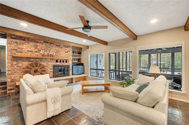 living room featuring ceiling fan, plenty of natural light, and a textured ceiling