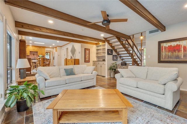 living room featuring beam ceiling and ceiling fan