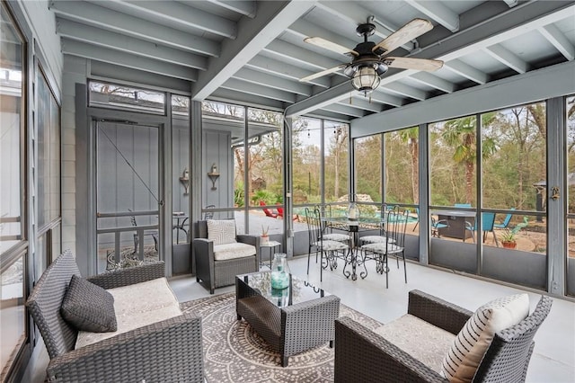 sunroom featuring beamed ceiling and ceiling fan