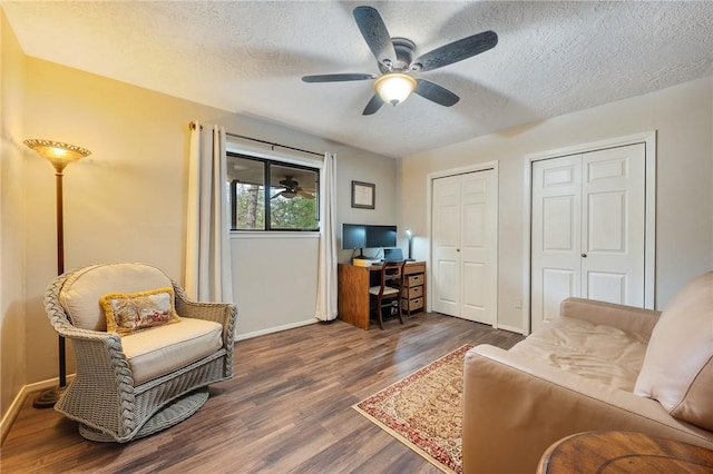 interior space with dark hardwood / wood-style floors, ceiling fan, and a textured ceiling