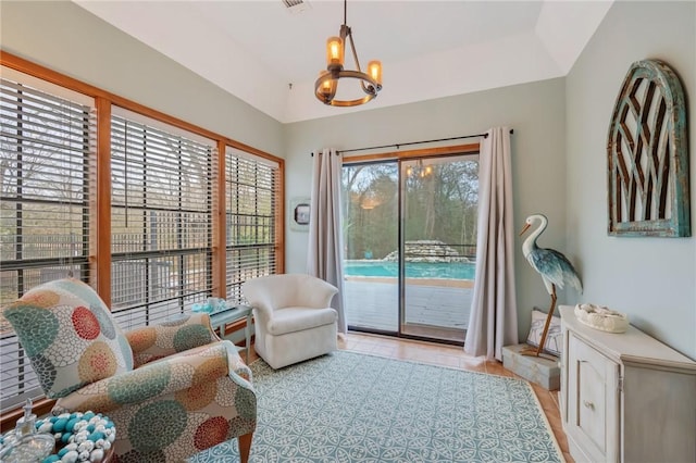 sitting room with a chandelier and light tile patterned floors