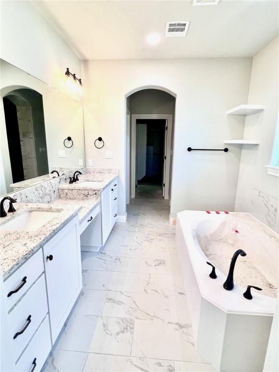 bathroom featuring vanity and a bathtub