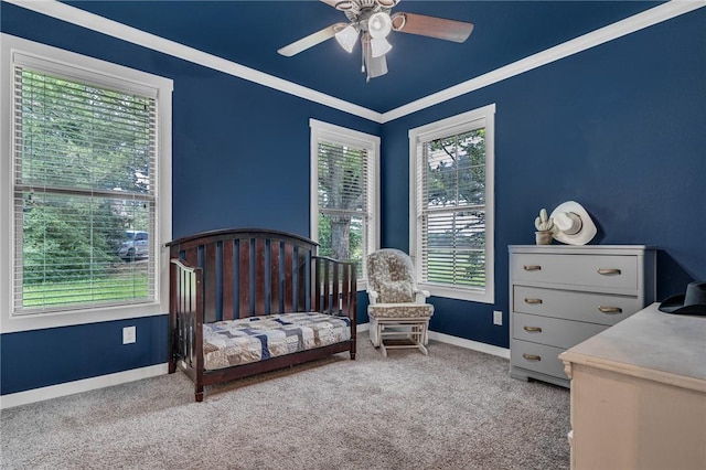 bedroom with multiple windows, ceiling fan, carpet floors, and ornamental molding