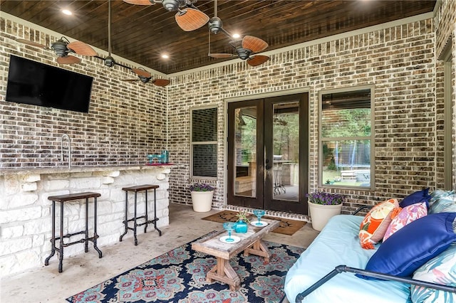 view of patio / terrace with ceiling fan, an outdoor living space, and french doors