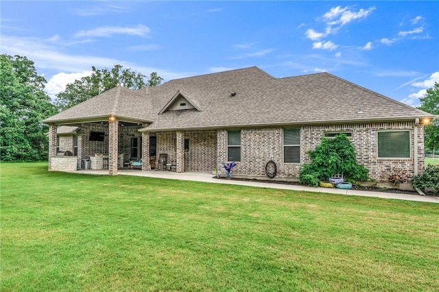 back of house featuring a lawn and a patio area