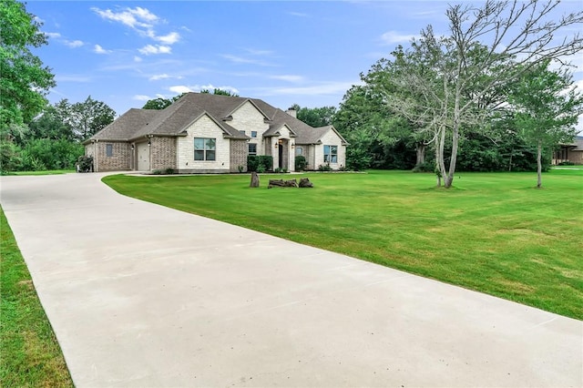 french country style house with a front lawn