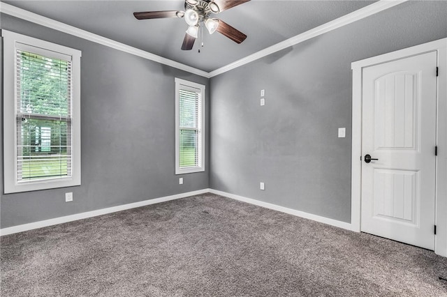 empty room with carpet flooring, ceiling fan, and ornamental molding