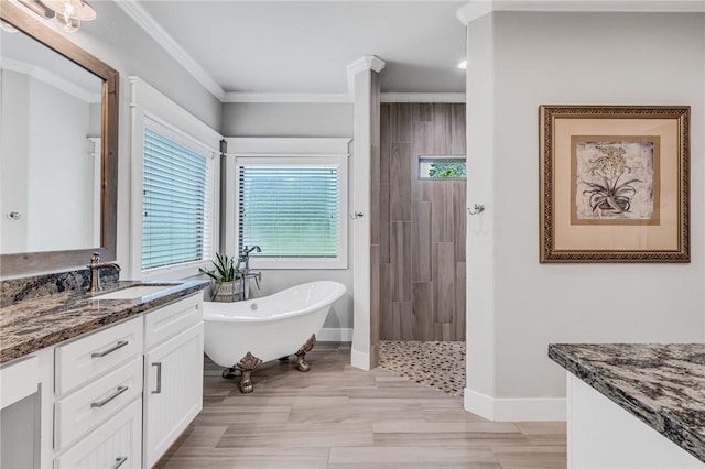 bathroom with vanity, ornamental molding, and shower with separate bathtub