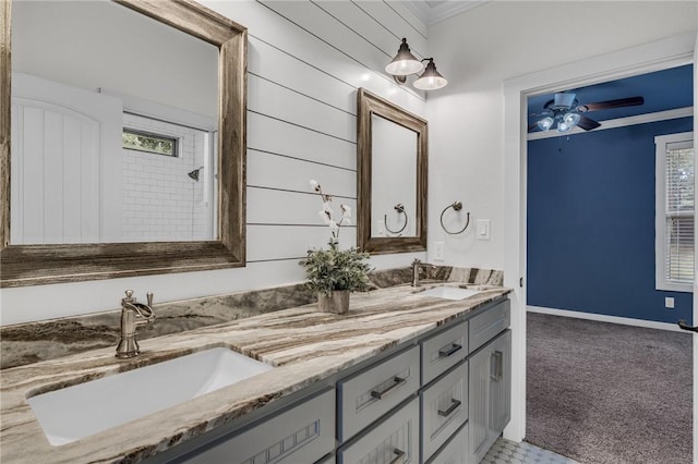 bathroom featuring crown molding, vanity, wood walls, and ceiling fan