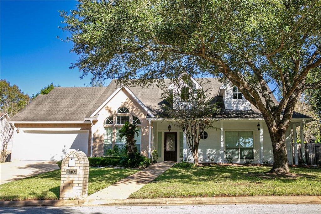 view of front of home featuring a garage and a front lawn