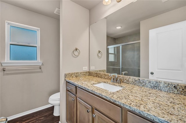 full bathroom featuring vanity, visible vents, a stall shower, baseboards, and toilet