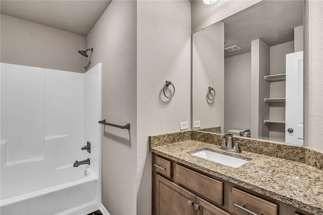 full bathroom featuring washtub / shower combination, vanity, toilet, and visible vents