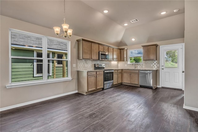 kitchen with visible vents, tasteful backsplash, pendant lighting, lofted ceiling, and stainless steel appliances