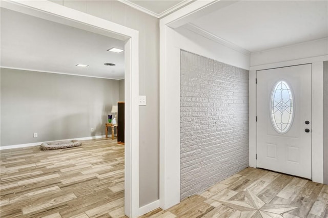 entryway with crown molding and light wood-type flooring