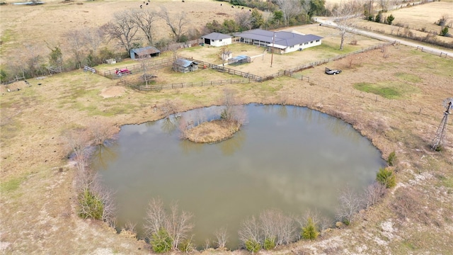 birds eye view of property with a water view and a rural view