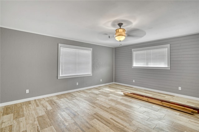 unfurnished room featuring crown molding, ceiling fan, and light hardwood / wood-style flooring