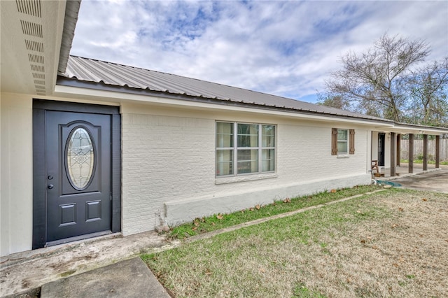 doorway to property with a yard