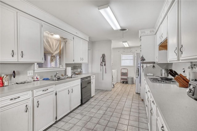 kitchen featuring light tile patterned flooring, sink, white cabinetry, black dishwasher, and stainless steel gas stovetop