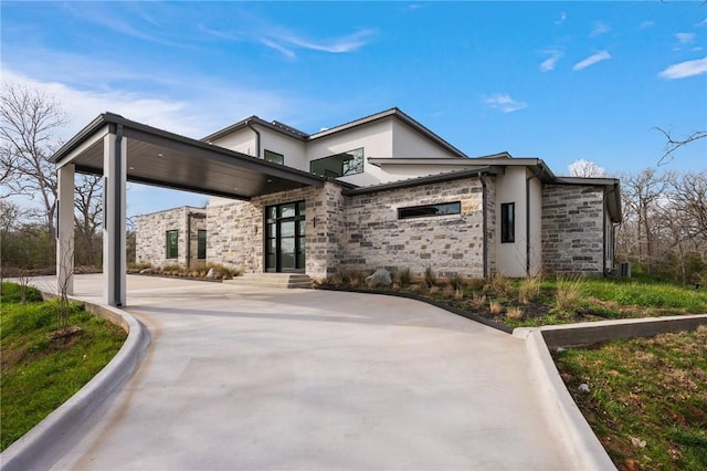 view of property exterior with stucco siding and stone siding