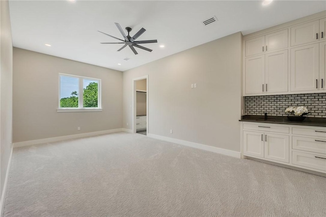 kitchen with open floor plan, baseboards, ceiling fan, dark countertops, and recessed lighting