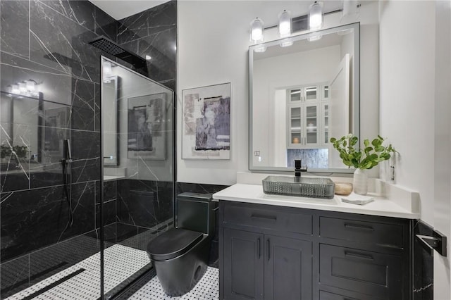 full bath featuring a marble finish shower, toilet, and vanity