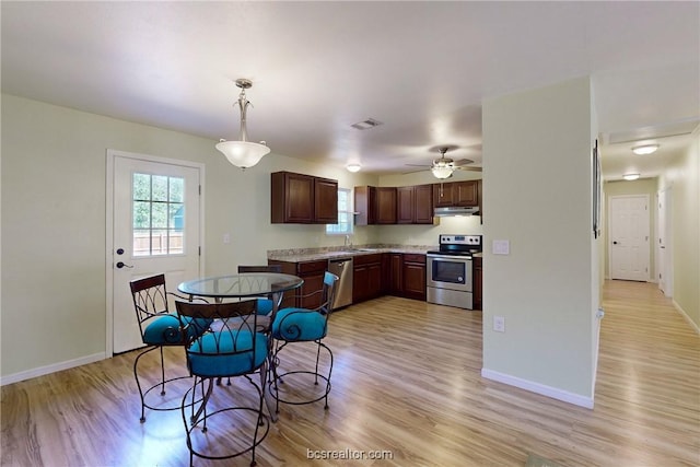 kitchen with ceiling fan, sink, hanging light fixtures, light hardwood / wood-style floors, and appliances with stainless steel finishes