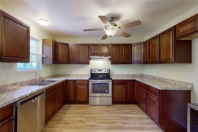 kitchen featuring ceiling fan, sink, wine cooler, appliances with stainless steel finishes, and light wood-type flooring