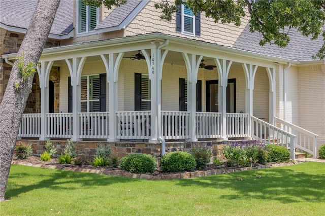 10560 St John Dr, Iola, TX 77861 - view of property exterior featuring ceiling fan, covered porch, roof with shingles, and a yard