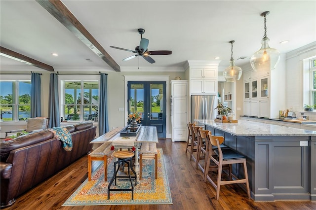10560 St John Dr, Iola, TX 77861 - kitchen featuring open floor plan, white cabinets, light stone countertops, crown molding, and beamed ceiling