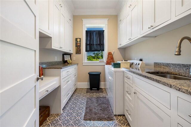 10560 St John Dr, Iola, TX 77861 - clothes washing area featuring washing machine and dryer, cabinet space, ornamental molding, and baseboards