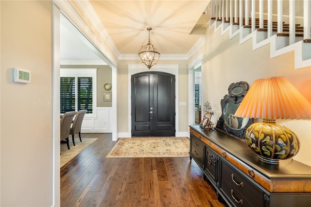 10560 St John Dr, Iola, TX 77861 - foyer entrance with ornamental molding, a chandelier, and dark wood finished floors