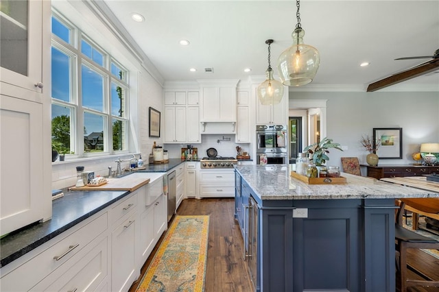 10560 St John Dr, Iola, TX 77861 - kitchen with appliances with stainless steel finishes, ornamental molding, white cabinetry, recessed lighting, and a sink