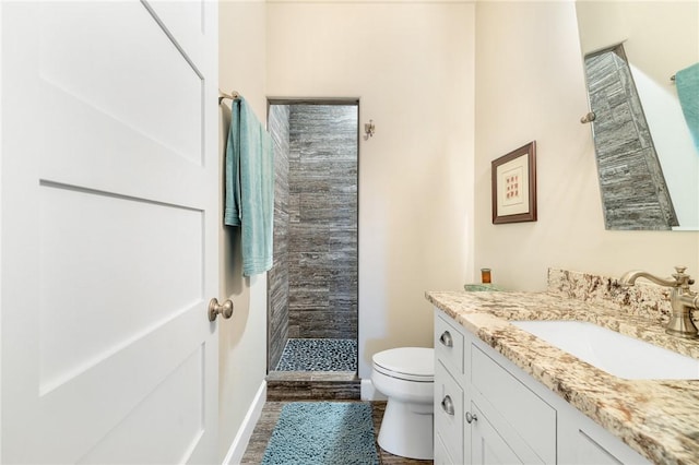 10560 St John Dr, Iola, TX 77861 - bathroom with toilet, a tile shower, vanity, and wood finished floors