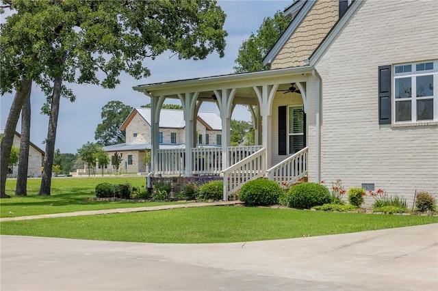 10560 St John Dr, Iola, TX 77861 - view of front of home with a ceiling fan, a porch, and a front lawn