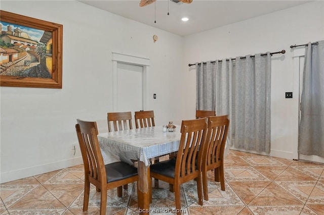 dining space with ceiling fan and light tile patterned flooring