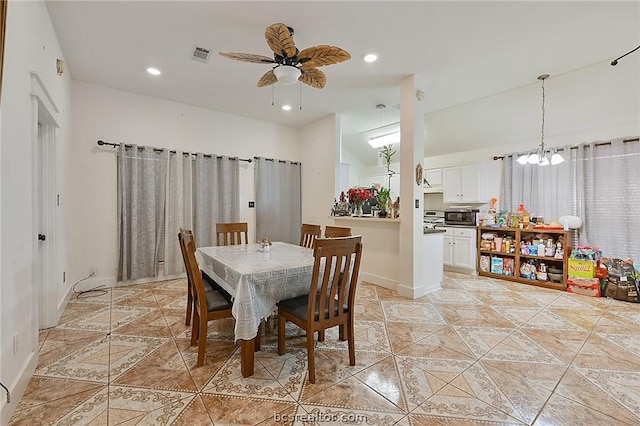 dining space featuring ceiling fan with notable chandelier