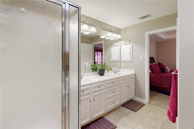 bathroom with vanity, a shower with shower door, and tile patterned floors