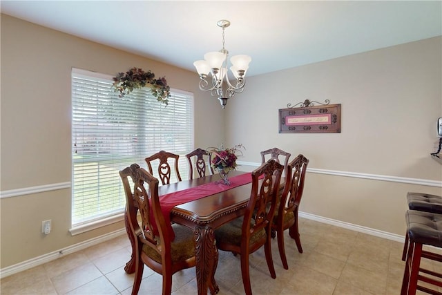 dining space featuring a notable chandelier