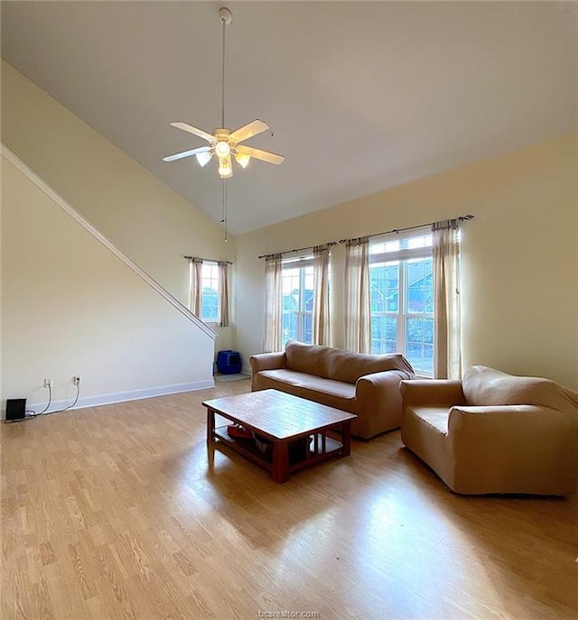 801 Luther St W Unit 401, College Station, TX 77840 - living room with light wood-type flooring, ceiling fan, baseboards, and high vaulted ceiling