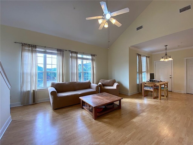 801 Luther St W Unit 401, College Station, TX 77840 - living area featuring baseboards, light wood-type flooring, ceiling fan, high vaulted ceiling, and a chandelier