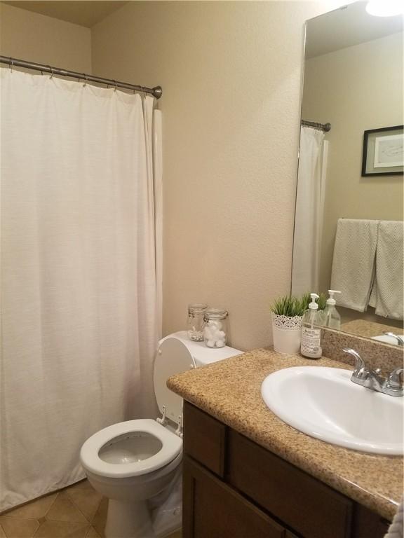 bathroom with tile patterned floors, toilet, and vanity
