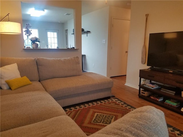 living room with wood finished floors and baseboards