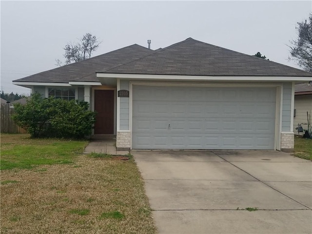 single story home featuring a garage, a shingled roof, concrete driveway, and stone siding