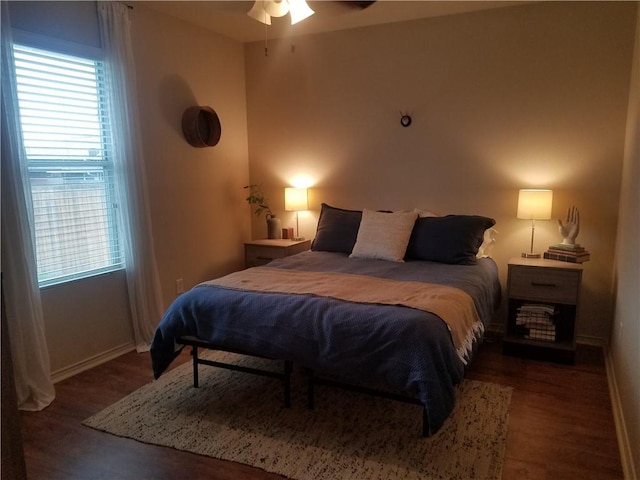 bedroom with wood finished floors and baseboards