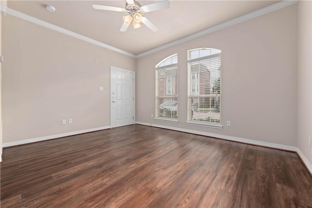 empty room featuring crown molding, ceiling fan, and dark wood-type flooring