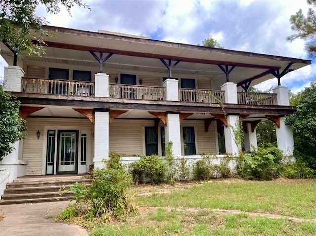 rear view of property featuring a lawn