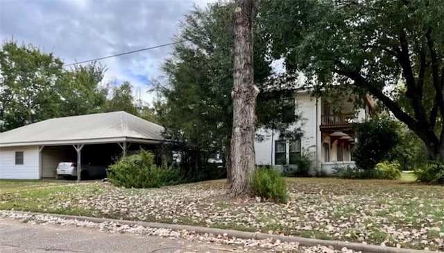 view of front of home with a carport and a balcony