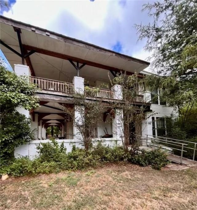 back of property with a balcony