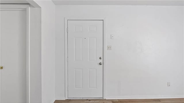 entryway with hardwood / wood-style flooring